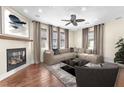 Cozy living room featuring a fireplace, hardwood floors, and comfortable seating at 1 Corte Belleza, Henderson, NV 89011