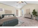 Spacious main bedroom with balcony access, vaulted ceilings, and ample natural light at 1 Corte Belleza, Henderson, NV 89011