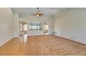 Spacious living room with a mix of hardwood floors and carpet, showcasing high ceilings and natural light at 10009 Netherton Dr, Las Vegas, NV 89134