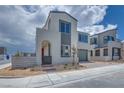 View of a modern two-story home, front gate, and tidy desert landscaping at 10433 Smokey Mariposa Ave, Las Vegas, NV 89166