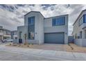 View of a modern two-story home featuring a two car garage and desert landscaping at 10433 Smokey Mariposa Ave, Las Vegas, NV 89166