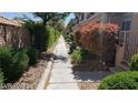 Landscaped sidewalk lined with well-manicured bushes and trees at 1236 Dusty Creek St, Las Vegas, NV 89128
