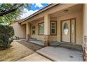 Welcoming front porch with decorative stone pillars and a beautiful front door at 12780 Davis Wright Ct, Henderson, NV 89044