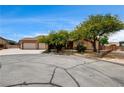 Inviting single-story home with well-manicured front yard and a three-car garage on a sunny day at 12780 Davis Wright Ct, Henderson, NV 89044