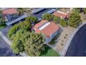 Overhead view of the condos showing roof lines, parking, mature trees, and landscaping at 1316 Capri Dr # Abc&D, Boulder City, NV 89005