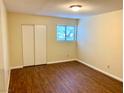 Cozy bedroom with wood floors, a window, and a closet perfect for relaxation at 1316 Capri Dr # Abc&D, Boulder City, NV 89005
