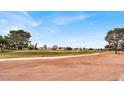 Scenic view of a lush green golf course with mature trees and well-maintained fairways under a clear sky at 2559 Winterwood Blvd, Las Vegas, NV 89142