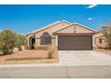Exterior view of home featuring well maintained desert landscaping with a two car garage at 2860 Galena Peak Ln, Las Vegas, NV 89156