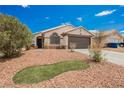 View of the home showing desert landscaping and the two-car garage at 2860 Galena Peak Ln, Las Vegas, NV 89156
