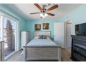 Cozy bedroom with a ceiling fan and sliding glass door to the backyard at 3143 La Mesa Dr, Henderson, NV 89014