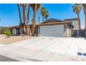 Spacious single-story home with desert landscaping, large driveway and an attached two-car garage at 3143 La Mesa Dr, Henderson, NV 89014
