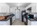 Bright kitchen featuring white cabinets, black appliances, and ample counter space at 3143 La Mesa Dr, Henderson, NV 89014