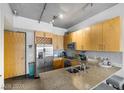 Bright kitchen with stainless steel appliances, a wine rack, and granite countertops with a double sink at 353 E Bonneville Ave # 555, Las Vegas, NV 89101