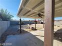 Covered patio overlooking a spacious backyard with a block wall, a small shed, and sparse greenery at 4321 El Conlon Ave, Las Vegas, NV 89102
