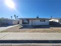 A quaint single-story home exhibiting desert landscaping with a driveway leading to a detached garage at 4321 El Conlon Ave, Las Vegas, NV 89102