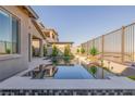 Stunning pool with decorative tile, lush landscaping, and a view of the surrounding homes at 436 Crown Mesa Ave, Las Vegas, NV 89138