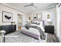 Cozy bedroom with a lilac bed, soft lighting, and stylish décor at 472 Via Stretto Ave, Henderson, NV 89011