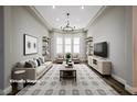 Spacious living room featuring large windows, neutral colors, and elegant decor at 472 Via Stretto Ave, Henderson, NV 89011