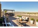 Spacious rooftop deck offering city views, lounge seating, and a dining area at 472 Via Stretto Ave, Henderson, NV 89011