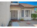 Inviting front entryway with a decorative double door, brick accents, a bay window, and desert-friendly landscaping at 4773 Sarazen Cir, Las Vegas, NV 89103