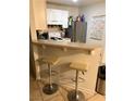 Bright eat-in kitchen with bar seating and stainless steel appliances at 520 Elm Dr # 202, Las Vegas, NV 89169