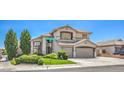 Attractive two-story home with desert landscaping, three-car garage, and a well-manicured lawn at 6301 Citrine Ave, Las Vegas, NV 89130