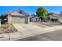 This single-story home features a well-manicured front yard and a two-car garage at 6771 Shelter Ln, Las Vegas, NV 89103