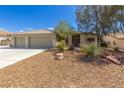 Lovely single-story home with desert landscaping, a large driveway, and a convenient three-car garage at 6908 Bienville St, Las Vegas, NV 89131