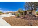 Charming single-story home with a well-manicured front yard, desert landscaping, and a spacious three-car garage at 6908 Bienville St, Las Vegas, NV 89131
