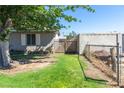 Back yard with partial fencing and some grass at 7 Sturm St, Henderson, NV 89015