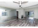 Bright living room featuring wood-look floors, a fireplace, and a mirrored wall for added space at 7100 Pirates Cove Rd # 2065, Las Vegas, NV 89145