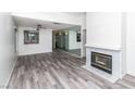 Open living area with modern flooring, fireplace, and views into the updated kitchen at 7100 Pirates Cove Rd # 2065, Las Vegas, NV 89145