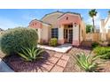 Beautifully landscaped home with manicured shrubs and desert accents at 8205 Harrogate Ave, Las Vegas, NV 89129