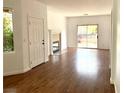 Bright living room with wood floors, fireplace, and sliding glass doors to a balcony at 9236 Canalino Dr, Las Vegas, NV 89134