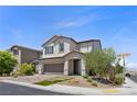 Lovely two-story home featuring desert landscaping and brick-paved driveway at 9430 Isla Lee Ave, Las Vegas, NV 89178