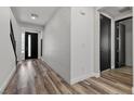 Hallway with wood floors and textured white walls leading to the front door at 9430 Isla Lee Ave, Las Vegas, NV 89178