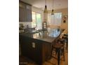 The kitchen has a large island, granite countertops, and stainless steel appliances at 9589 Comiskey Ct, Las Vegas, NV 89148