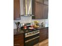 The kitchen features stainless steel appliances and dark wood cabinets at 9589 Comiskey Ct, Las Vegas, NV 89148