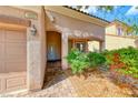 Close-up of the front entrance featuring a tiled entryway and well-maintained landscaping at 1033 Logan Patrick Dr, Henderson, NV 89052