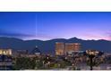 Breathtaking city view showcasing illuminated buildings against a twilight sky and the distant mountain range at 10470 Dove Meadow Way, Las Vegas, NV 89135