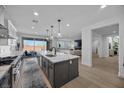 Contemporary kitchen boasting an expansive island, modern appliances, and seamless access to an outdoor patio at 10470 Dove Meadow Way, Las Vegas, NV 89135