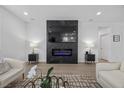 Modern living room featuring a sleek fireplace and minimalist decor with comfortable seating at 10470 Dove Meadow Way, Las Vegas, NV 89135