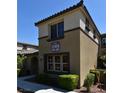 Two-story condo featuring a well-maintained lawn, arched entryway and clearly displayed address number at 11416 Belmont Lake Dr # 102, Las Vegas, NV 89135