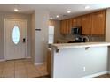 Bright kitchen featuring tile floors, breakfast bar, and modern appliances with great natural light at 1152 Paradise Desert Ave, Henderson, NV 89002