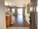 Inviting living room featuring sleek wood floors and sliding door leading to outdoor space at 1152 Paradise Desert Ave, Henderson, NV 89002