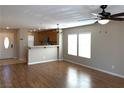 Open-concept living room with wood floors and an eat-in kitchen area providing an inviting, light-filled space at 1152 Paradise Desert Ave, Henderson, NV 89002