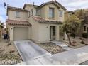 Inviting two-story home with a well-maintained lawn, desert landscaping, and an attached one car garage at 11882 Snow Bank St, Las Vegas, NV 89183