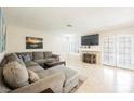 Spacious living room featuring tile floors, a cozy couch, and abundant natural light at 2008 Spruce Brook Dr, Henderson, NV 89074