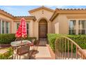 Inviting front entrance with a charming outdoor seating area and a beautifully landscaped walkway at 215 Great Gable Dr, Las Vegas, NV 89183