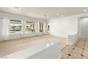 Bright and airy living room with large windows providing views of the pool area at 215 Great Gable Dr, Las Vegas, NV 89183